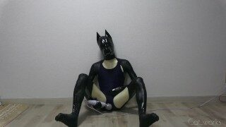 Latex dog crossdresser wearing latex catsuit and one-piece swimsuit